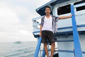 Man on wooden boat photo