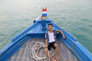 Man on wooden boat photo