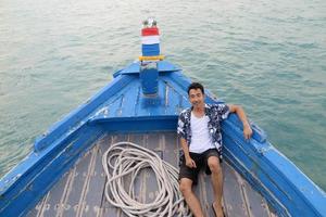 Man on wooden boat photo