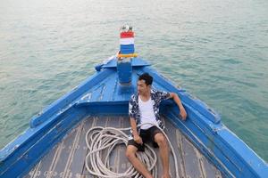 Man on wooden boat photo