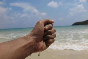 hand and beach photo