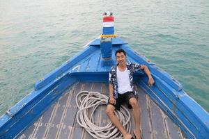 Man on wooden boat photo