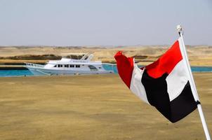 waving Egyptian flag in the port photo