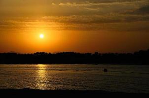 puesta de sol en vacaciones junto al mar foto