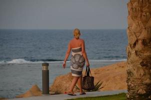 woman walking on way to beach photo