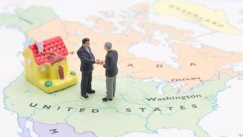 Businessman and house on map American. Miniature people photo