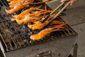 shrimp on the grill with hand photo