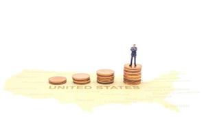 Miniature people, businessman standing on map American photo