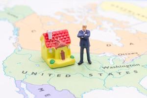 Businessman and house on map American. Miniature people photo