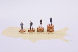 Miniature people, businessman standing on map American photo