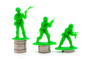 Toy Soldier on coin stacks a white background photo