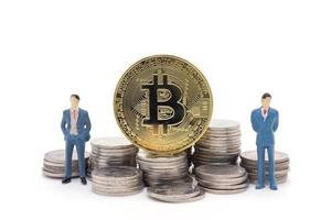 Miniature businessman and Bitcoin on white background photo