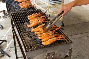 shrimp on the grill with hand photo