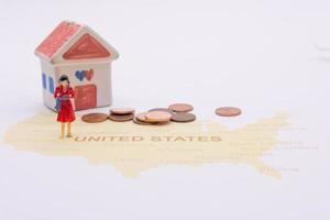 Businesswoman and house on map American. Miniature people photo