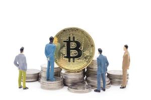 Miniature businessman and Bitcoin on white background photo