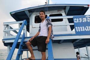 Man on wooden boat photo