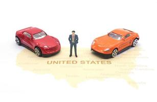 Miniature people, businessman and car on map American photo