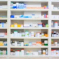 blur shelves of drugs in the pharmacy shop photo