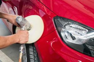 Worker cleaning the car photo