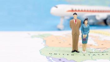 Miniature people, Couple standing on map American photo