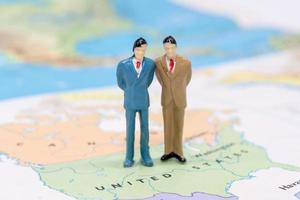 Miniature people, businessman standing on map American photo