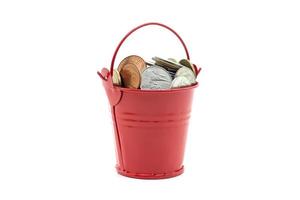 Small red bucket full of money on white background photo