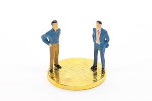 Miniature businessman and Bitcoin on white background photo