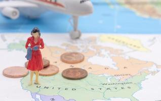 Miniature people, businesswoman standing on map American photo