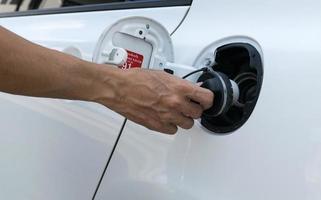 Hand opening the oil filler cap photo