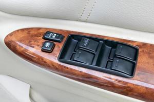 car interior details of door handle with windows controls and adjustments photo