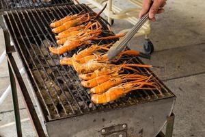 shrimp on the grill with hand photo