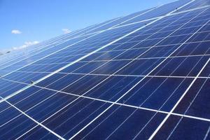 Solar Panels Against The Deep Blue Sky photo