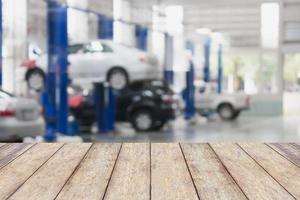 Wood table top with blur garage background photo