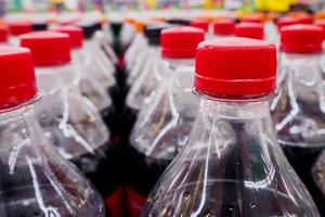 Carbonated soft drink bottles close up photo