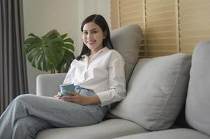 Young beautiful woman is working with her computer at home. photo