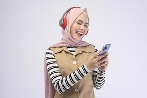 Young beautifu musliml woman wearing headset on white background photo