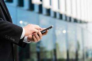 Image of a man holding a mobile phone in his hand photo