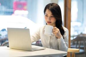 Asian businesswoman working at a cafe photo