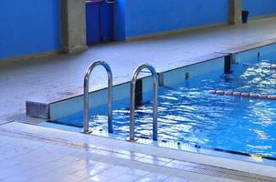 Swimming pool with blue water useful as background photo