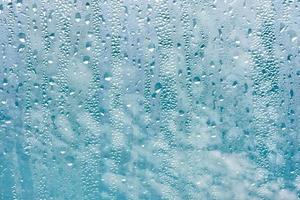 raindrops on the window and blue sky background photo