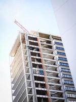 Modern multistory residential building under construction. Unfinished building view. photo