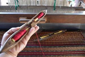 Weaving bobbins used with small looms made from wood for weaving in rural Thai households. photo