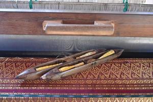 Weaving bobbins used with small looms made from wood for weaving in rural Thai households. photo