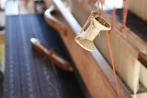 Weaving bobbins used with small looms made from wood for weaving in rural Thai households. photo