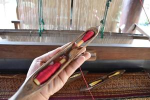 Weaving bobbins used with small looms made from wood for weaving in rural Thai households. photo