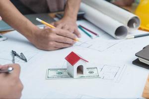 Architects engineer discussing on desk with blueprint. Team group on construciton site check documents and business workflow.Construction concept. Engineering tools.Vintage effect.Selective focus. photo