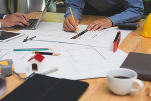 Team of architects or engineer discussing on desk with blueprint about new startup project on desk. Team group on construciton site check documents and business workflow.Selective focus. photo