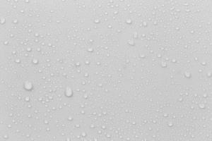 The concept of raindrops falling on a gray background Abstract wet white surface with bubbles on the surface Realistic pure water droplet water drops for creative banner design photo