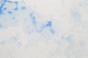 Blue watercolor on white paper, abstract background photo