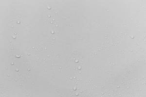 The concept of raindrops falling on a gray background Abstract wet white surface with bubbles on the surface Realistic pure water droplet water drops for creative banner design photo